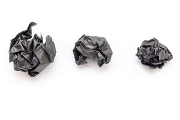 Real Black Paper crumpled as Ball, wrinkled paper texture, isolated on white Background