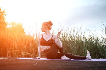 Girl practice yoga early morning on pier