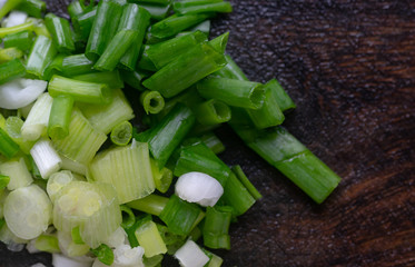 The sliced scallion on wooden board