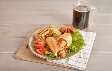hot dog with vegetables and beer on the oktoberfest table