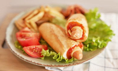 hot dog with vegetables and beer on the oktoberfest table