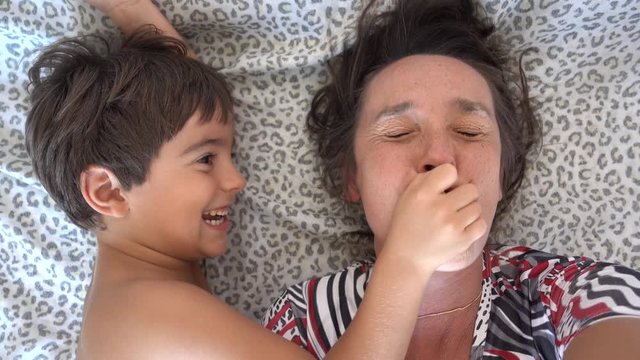 4K Selfie - Jokking kid shuts up nose and mouth of his mother