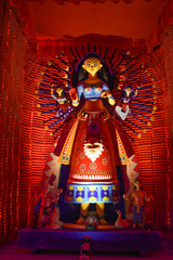 Idol of Goddess Devi Durga at a decorated puja pandal in Kolkata, West Bengal, India. Durga Puja is...