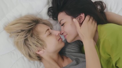 Lesbian couple kissing in the morning