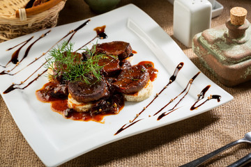 Braised meat  dish on white plate