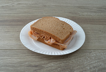 Thin sliced smoked turkey sandwich on a table