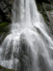 Mountain waterfall. The flow of the waterfall of mountain river.