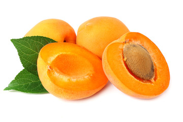 apricot fruits with slices and green leaf isolated on white background.