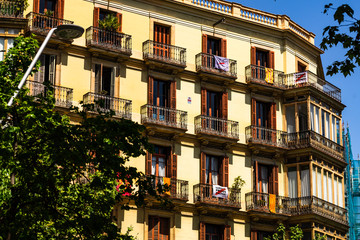Barcelona, Spain – 2019. Apartments building with political massages posted on the balcony.