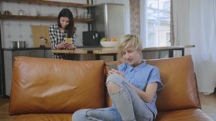 Young lesbian couple using gadgets