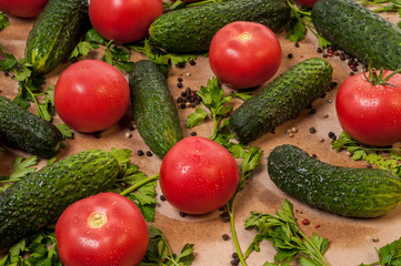 Organic vegetables tomatoes cucumbers parsley over craft paper. Zero waste, plastic free concept. Healthy clean eating diet and detox. Top view, flat lay. Veggie ingredients for cooking.
