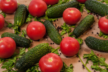 Organic vegetables tomatoes cucumbers parsley over craft paper. Zero waste, plastic free concept. Healthy clean eating diet and detox. Top view, flat lay. Veggie ingredients for cooking.