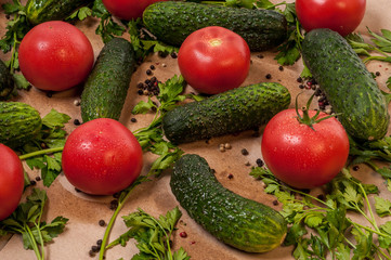 Organic vegetables tomatoes cucumbers parsley over craft paper. Zero waste, plastic free concept. Healthy clean eating diet and detox. Top view, flat lay. Veggie ingredients for cooking.