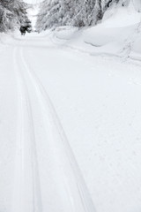 mountain route with cross country skiing trace in winter