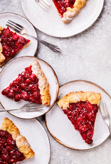 Bakery products. Summer pie with berries. Galeta with cherries sprinkled with powdered sugar.