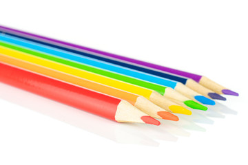 Group of seven whole colored pencil rainbow colors isolated on white background