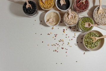 Assortment of beans and lentils in wooden bowl and spoon on clear background. mung bean, groundnut,...