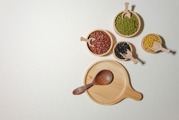 Assortment of beans and lentils in wooden bowl and spoon on clear background. mung bean, groundnut,...