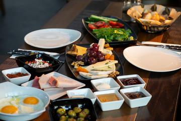 Breakfast with fried egg and cheese plate on wooden table