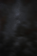 Milky way in the night sky through the clouds on a summer night