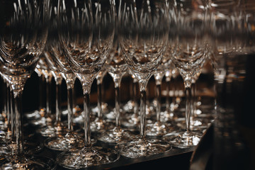 Empty clean champagne glasses on counter in bar.