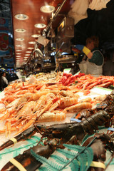 Fresh shellfish on the market desk. Lobsters, langoustine, shrimps, nephrons, prawns