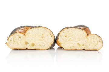 Group of two halves of twisted poppy seed bun cross section isolated on white background