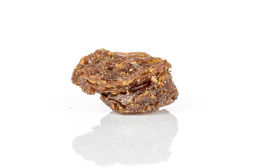 One piece of raisin of lingonberry strawberry fruit tea macro isolated on white background