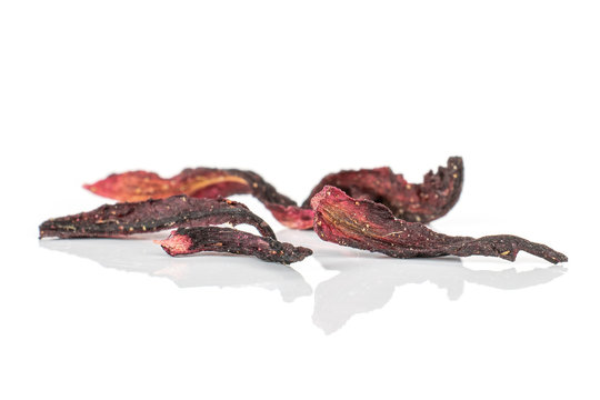 Group of five pieces of hibiscus flower of lingonberry strawberry fruit tea macro isolated on white background