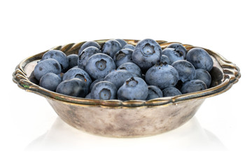 Lot of whole fresh blue bilberry in metal bowl isolated on white background