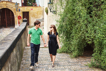 young couple in love walking on a street of European city. sightseeing traveler