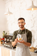 Fototapeta na wymiar Entrepreneur owning coffee shop holding cup of cappuccino