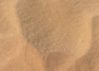 Fototapeta na wymiar Texture of brown sand 