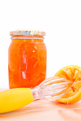 Oranges with a bottle of marmalade, against white isloated background