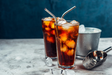 Cold brew coffee in a glass with metal straw on a dark background.Iced coffee