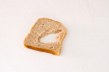 A slice of bread with a chunk missing in the middle isolated on a white background image with copy space