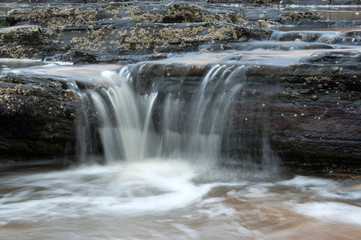 Dirty water flowing from storm water drains into the sea South Africa