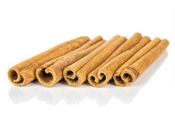 Group of five whole dry brown cinnamon isolated on white background