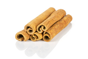 Group of five whole dry brown cinnamon isolated on white background