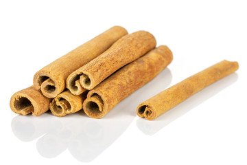 Group of six whole dry brown cinnamon isolated on white background