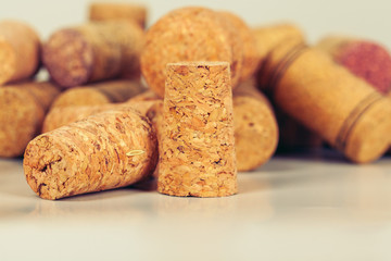 Heap of assorted wine corks on wooden background