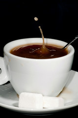 Coffee cup white, droplet of coffee splashing
