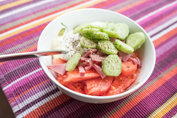 Salad of fresh cucumbers, tomatoes, beef, black pepper, sour cream, mayonnaise. Salad do not mix