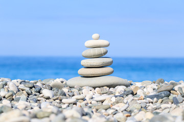 Stones balance on a background of sea. Calm and meditation. Concept of harmony and balance