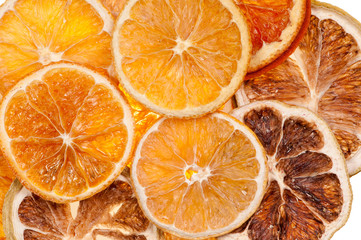 Sliced dried orange pieces against white background