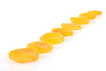 Lot of whole dried orange apricot isolated on white background