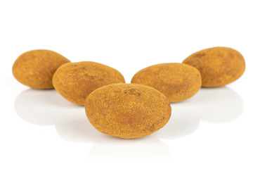 Group of five whole sweet brown chocolate cinnamon almond isolated on white background