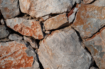 Modern wall of large unprocessed pieces of rock, stones. Background stone wall.