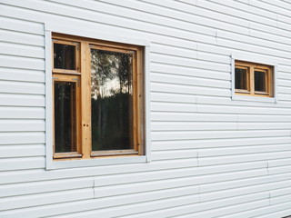 frame house sheathed in white siding