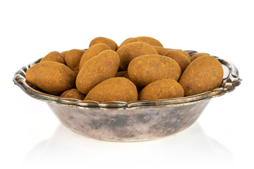 Lot of whole sweet brown chocolate cinnamon almond in metal bowl isolated on white background
